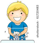 a young boy washing his hands   ...