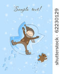 happy boy making a snow angel...