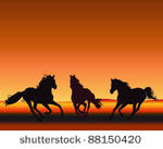 three horses gallop silhouetted ...